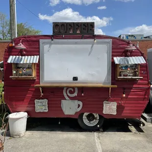 a red trailer with a sign on top