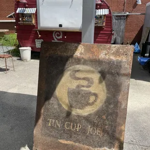 an old tin cup joe sign