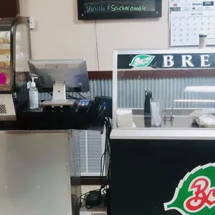 a bakery counter with a beverage dispenser