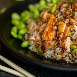 a plate of fried rice with chicken and peas