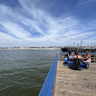  people sitting on a pier