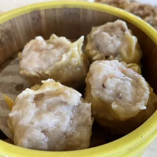 a yellow bowl filled with dumplings