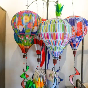 Up your outdoor decor game with one of our fun wind spinners like these hot air balloons!  Lots of style online and instore.