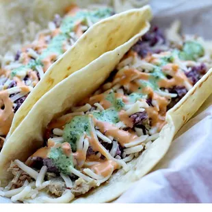 Pork taco, cilantro lime coleslaw, chipotle mayo, shredded queso cheese