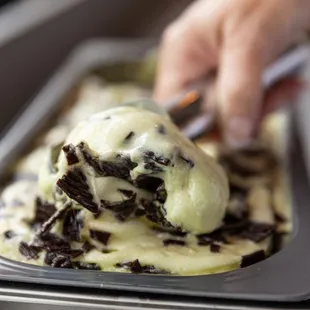 a person scooping a scoop of ice cream