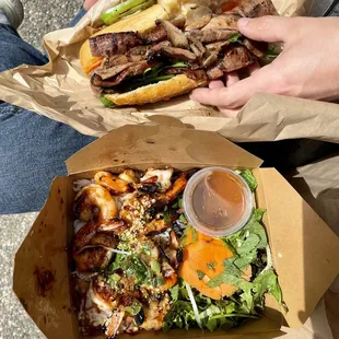 two people eating sandwiches