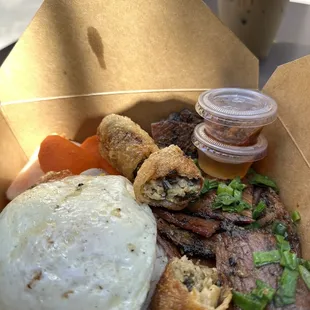 Lemongrass Pork rice plate with fried egg and an egg roll. Also ordered an Iced Vietnamese Coffee.