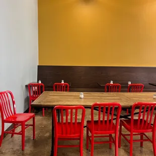 a long table with red chairs