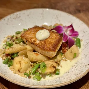 Pan Seared Scottish Salmon with artichoke hearts, sugar snap peas, asparagus, roasted tomatoes, rainbow carrots, and fregola