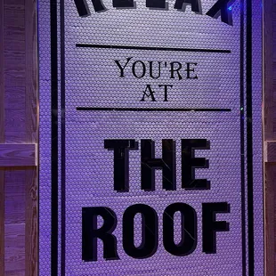 a sign that reads relax you're at the roof