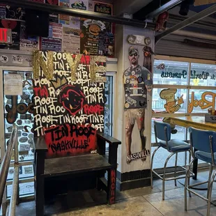 the inside of a restaurant with a bench and tables