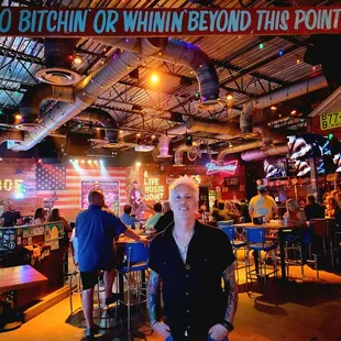 a man standing in front of a bar
