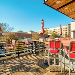 a deck with chairs and umbrellas