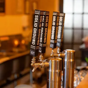 a row of beer taps