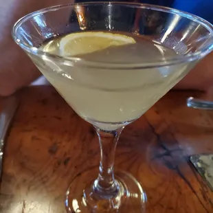 a martini with a lemon slice in it