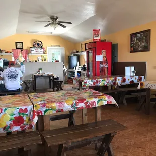 a dining area with tables and benches