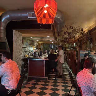 people sitting at tables in a restaurant