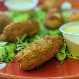 a plate of food with dipping sauce