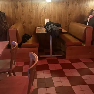 a woman sitting at a table in a restaurant