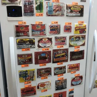 a refrigerator with a lot of tins on it