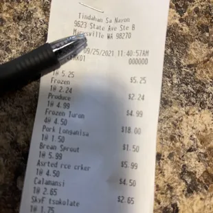 a receipt and a pen