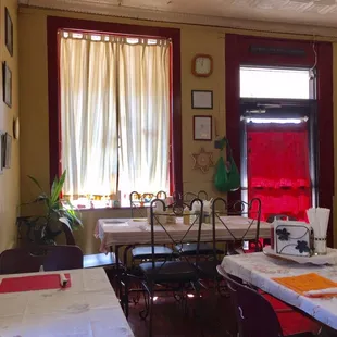 a dining room with tables and chairs