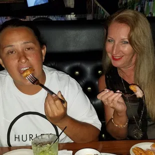 a man and a woman eating food