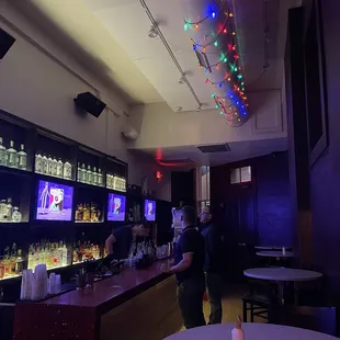 people in a bar watching televisions