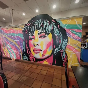 ows a woman's face painted on a wall