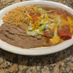 Enchilada plate. Two enchiladas, rice, refried beans and small salad.
