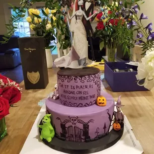 a bride and groom on top of a wedding cake