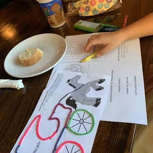 Kids menu/activity sheet with crayons and some kids craft item