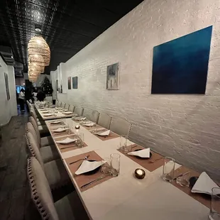 a long dining table with place settings