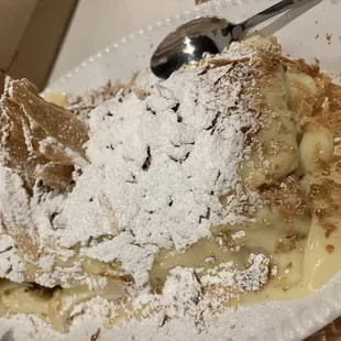 a plate of food with powdered sugar on top