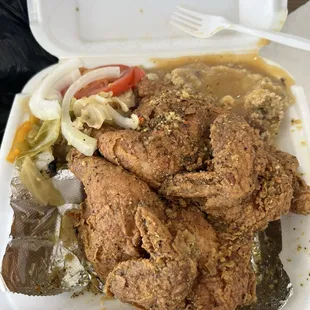 Deep fried hen with cabbage medley and dressing and gravy. Hen is topped with lemon pepper.