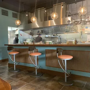 a kitchen with a counter and stools