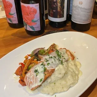 Seared Salmon with mashed potatoes, mixed vegetables, and lemon cream sauce