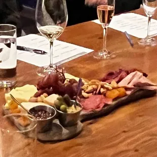 a woman sitting at a table with wine glasses