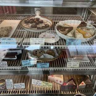a display case with a variety of desserts