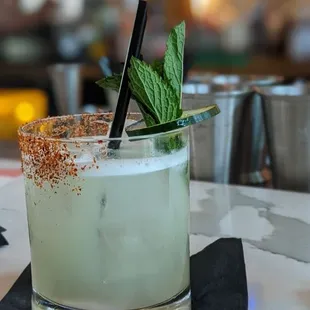 a drink with a garnish garnish