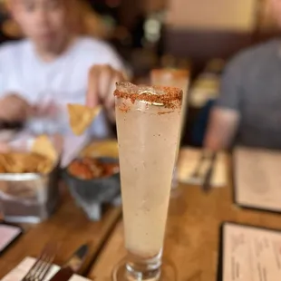 a tall glass with a drink in it