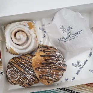 Cinnamon roll, two chocolate croissants and a ham and cheese croissant in the little bag.
