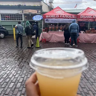 a person holding a cup of juice