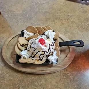 Chocolate Maria Skillet Brownie on the bottom cookies on the side. Ice cream on the top with whipped cream cherry hot fudge &amp; caramel sauce.