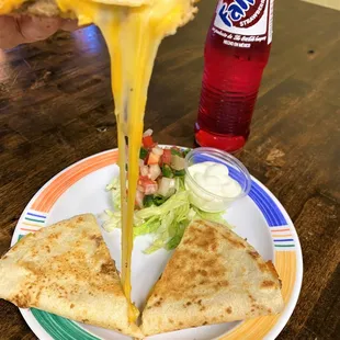 a quesadilla being lifted by a fork