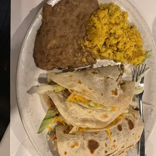 2 beef 1 chicken soft taco dinner with refried beans and Mexican rice.