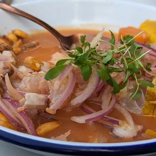 Ceviche Mixto (snapper, shrimp, octopus), with plantain chips, red onion, sea island red peas, and sweet potato as accompaniments