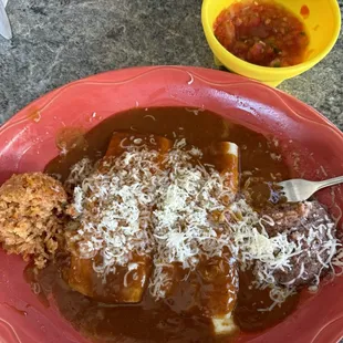 2 cheese enchiladas with dark sauce, rice and beans.
