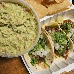 Carne asada tacos, chips, and guac.