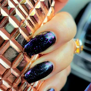 Black gel polish with glitter top coat.